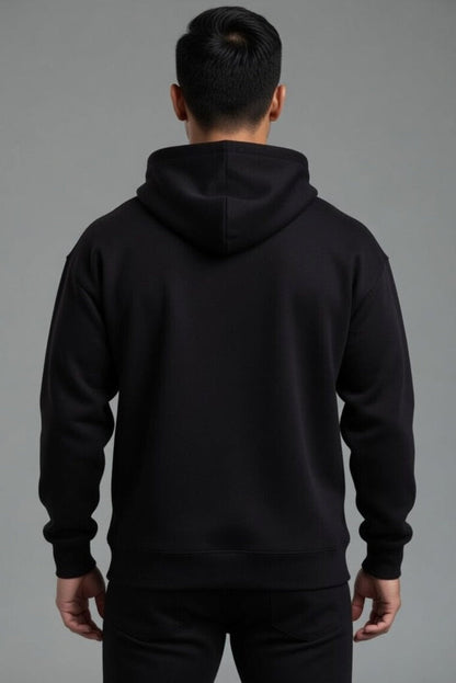 Person wearing a black hoodie from behind on a gray background  || Black