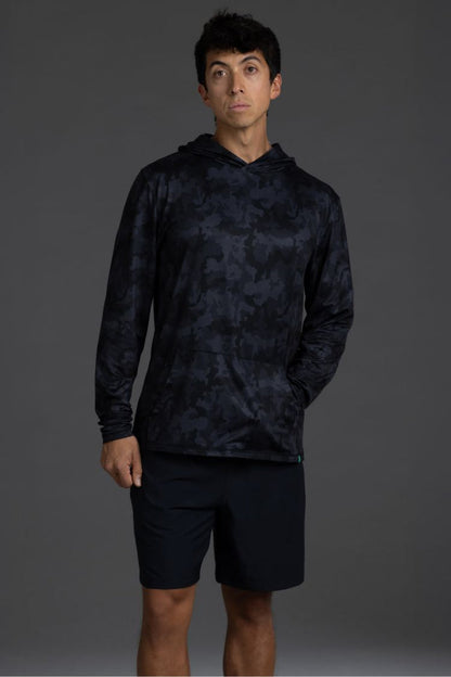Person wearing a black camouflage hoodie and shorts on a gray  background || Black Camo