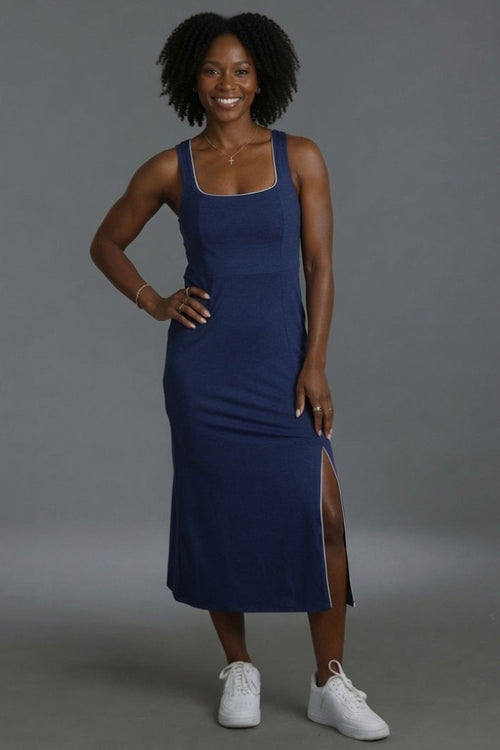 Woman wearing a blue dress with a gray background || Navy