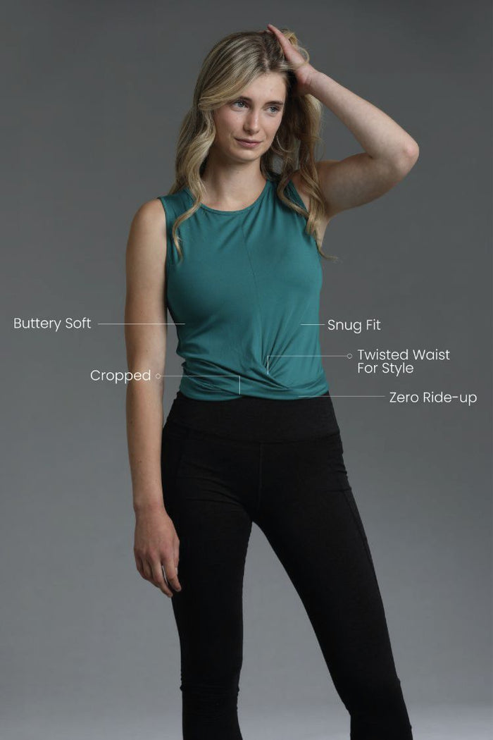 Woman wearing a teal sleeveless top and black pants with text describing garment features. || Teal